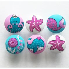 six buttons with different designs on them