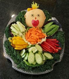 a platter filled with vegetables and a stuffed animal