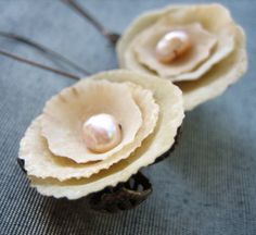 two flower shaped objects sitting on top of a blue cloth covered tablecloth with wire