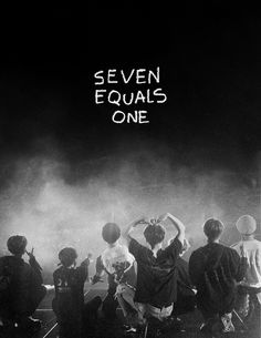 seven equals one is standing in front of a crowd