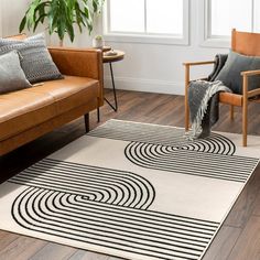 a living room with two couches and a rug on the floor