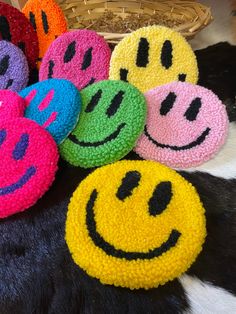 multicolored crocheted smiley face bath sponges on black and white cowhide