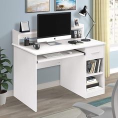 a white computer desk with a monitor and keyboard