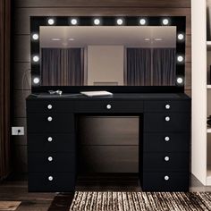 a black vanity with lights on it and a rug in front of the mirror that is lit up