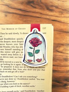 a bookmark with an image of a rose in a bell on top of it