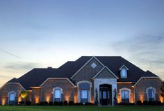 a large brick house lit up at night