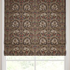 a window with a brown and red patterned roman blind