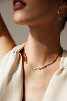 Centauri's Herringbone Snake Chain Necklace is a must-have for everyday wear. Its herringbone chain gives it a unique look that's still subtle enough for any occasion. It's also water resistant and tarnish resistant, making it a reliable accessory. Enjoy a stylish look that won't let you down. MATERIAL: 18k Gold plated, Stainless steel SIZE: 16" or 18" (Available in silver - Check out our Silver Collection!) Water resistant, tarnish resistant, hypoallergenic, & nickel/lead free. Elegant Jewelry Photoshoot, Jewelry Model Photoshoot, Jewellery Lifestyle Photography, Classic Everyday Snake Chain Necklace With Clavicle Chain, Dainty Herringbone Necklace With Box Chain, Dainty Everyday Herringbone Necklace With Box Chain, Everyday Gold Snake Chain Necklace, Minimalist Herringbone Necklace For Everyday, Minimalist Everyday Herringbone Necklace