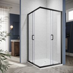 a bathroom with a corner shower and blue walls