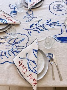 a table set with place settings and napkins