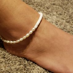 Flores Puka & Anklet Ankle Bracelet What's better than a bestselling anklet? An anklet that combines two of our customer favorites! Introducing the Flores Puka Shell & Pearl Anklet. Half puka shell, and half pearl, this fresh design is guaranteed to add a bit of luxury to your surf style. * Biodegradable packaging. * Handmade in Bali. * Freshwater pearl and puka shell beads. * Anklet measures approx. 9 1/2 -10" with a 2" chain extender. Pearl Ankle Bracelet, Beads Anklet, Packaging Handmade, Star Anklet, Pearl Anklet, Biodegradable Packaging, Puka Shell, Chain Extenders, Surf Style