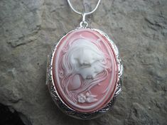 Beautiful cameo locket!!!  The cameo is beautifully detailed!!!  Wonderful gift for sisters, mothers, daughters, and friends!!!! The locket is victorian style with beautiful scroll on the front and back about 1 3/4" long.  It can hold two photos, keepsakes, or even your daily medication or vitamins!!! Pass down from generation to generation!!! The chain is 22"  1.2mm .925 plated snake chain with a lobster claw clasp!!! Perfect  for Brides or Bridal parties.  Makes a unique memorable gift for any Cameo Medallion Locket Necklace Keepsake, Cameo Medallion Locket Necklace For Keepsake, Keepsake Medallion Locket Necklace With Cameo, Victorian Cameo Locket Necklace As A Gift, Elegant Cameo Locket Necklace For Wedding, Pink Locket Jewelry For Mother's Day, Mother's Day Pink Locket Jewelry, Cameo Medallion Locket Necklace For Weddings, Pink Cameo Jewelry For Wedding