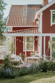 a red house with white trim and green shutters on the front door is featured in instagram