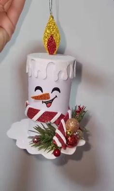 a christmas ornament hanging from the side of a wall with a cake on it