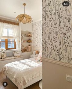 a bedroom with floral wallpaper and white bedding