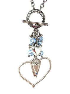 a heart shaped key chain with blue beads and charms hanging from it's sides