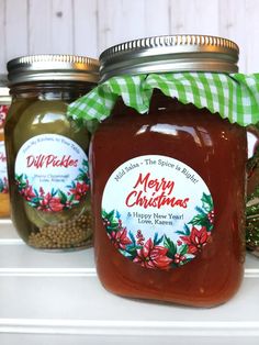 three jars filled with jam sitting on top of a white shelf next to each other