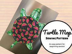 a turtle made out of paper sitting on top of a piece of lined paper with the words turtle mop sewing pattern below it