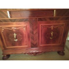 an ornate wooden cabinet with two doors