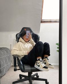 a person sitting in an office chair taking a selfie