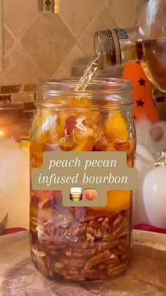 a jar filled with fruit and nuts sitting on top of a counter