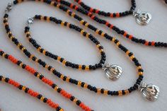 These fun and unique necklace and bracelet sets make a great addition to any Halloween costume. They are very nice and well made so you can wear them out or to the office to show that you are in the Halloween spirit and they will last for years. These jewelry sets also make a wonderful gift or party favor for your Halloween guests. The necklaces and bracelets are made with stretchy beading cord so this allows some flexibility in fit. I can make them to your desired length and also add a chain ex Halloween Festival Jewelry With Round Beads, Themed Black Beaded Jewelry, Bracelet Sets, Halloween Beads, Beading Cord, Halloween Necklace, Necklaces And Bracelets, Halloween Spirit, Charm Pendant Necklace