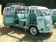 an old vw bus is parked in the grass