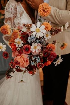 a bride and groom standing next to each other