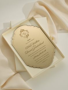 an elegant wedding card with gold foil on the front and back, sitting in a white box