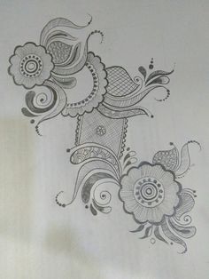 a drawing of flowers and swirls on paper