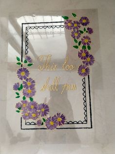 this too shall you sticker is in the shape of a wreath with purple and yellow flowers