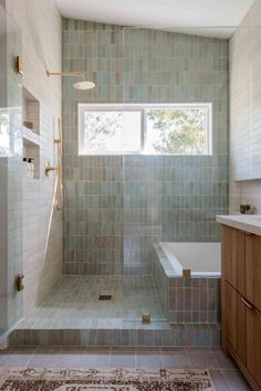 a bathroom with a tub, sink and shower