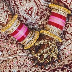 A bride's dream come true! The look includes bridal choora set for both hands which consists of beautiful red and pink bangles along with four classic bangles displaying a beautiful combination of kundan stones and gold-finished balls. Available in various sizes. Gold-plated on high-quality brass as base metal. Made by order. Kindly allow 5-7 weeks for the delivery of this item. For custom or urgent requests, please contact support@alacouture.com. *Please Note: We use faux stones and beads in al Red Zari Work Bangle Bracelet, Red Zari Work Bangle Bracelets, Red Bangle Bracelets With Zari Work, Pink Cutdana Bangle For Diwali, Traditional Red Hand Set Bridal Sets, Kundan Bridal Sets With Stone Work For Traditional Ceremonies, Traditional Kundan Bridal Sets With Stone Work, Red Tilla Bridal Sets For Marriage, Festive Pink Cutdana Bangle