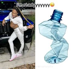 a woman in white pants leaning against a blue truck with an empty water bottle attached to it