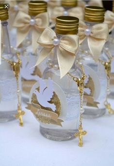 several bottles with gold and white decorations on them, one has a name tag attached to the bottle