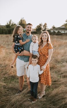 a family posing for a photo in an open field