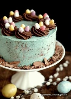 an easter cake with chocolate frosting and candy eggs