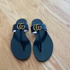 Authentic Gucci From Milan Store, Never Worn, Just Kept In Storage, Slick And Clean Leather, Slight Discoloration On G Over The Years Which Is Pictured, European Size 39 Fits U.S. Size 8.5/9 Gucci Designer Sandals With Single Toe Strap, Designer Gucci Sandals With Single Toe Strap, Luxury Black Leather Flip Flops, Chic Gucci Sandals With Single Toe Strap, Gucci Black Sandals With Single Toe Strap, Designer Flat Flip Flops For Beach, Designer Black Leather Flip Flops, Designer Black Toe Post Sandals, Designer Toe Post Sandals