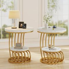 two side tables with marble top and gold metal legs, one has a magazine rack on it