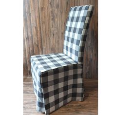 a black and white checkered chair sitting on top of a wooden floor