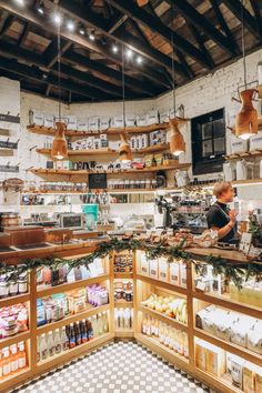 the inside of a store filled with lots of food and decorations on display in wooden shelves