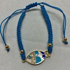 This Stylish Bracelet Features A Blue Macrame Fish Design And An Evil Eye Charm Bead. The Bracelet Is Made From High-Quality Materials, Including Cotton, Stainless Steel, And Cubic Zirconia. The Closure Is A Convenient Slide, Making It Easy To Put On And Take Off. The Bracelet Is 7.3 Inches In Length And Has A Wrap Style. It Is Perfect For Any Occasion And Can Be Worn With Both Casual And Formal Outfits. Made In Italy, This Bracelet Is A Must-Have For Any Fashion Jewelry Collection. Macrame Fish, Blue Macrame, Stylish Bracelet, Formal Outfits, Eye Bracelet, Evil Eye Charm, Fish Design, Evil Eye Bracelet, Formal Outfit