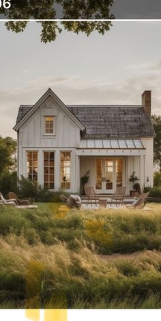 a white house sitting in the middle of a lush green field