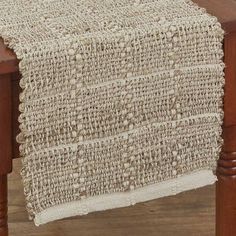 a close up of a wooden table with a white cloth on top of the table