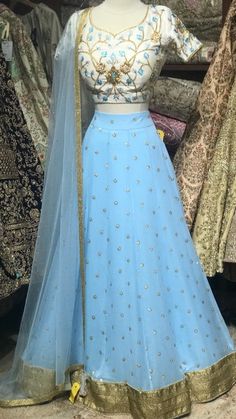 Baby Blue Bridemaids Lehenga with gold border. Blouse and lehenga stitching is included! Blouse style is same for entire order. Blouses are stitched to individual measurements but the shape of the neckline needs to be the same. For example- If you choose a sweetheart neckline all bridesmaids will have a sweetheart neckline but one bridesmaids can have the depth to be 8inches vs. the other can ask the neckline to be 10inches. Final fittings/alterations not included. Fabric: Georgette, Raw Silk Ou Blue Anarkali Set With Gota Work For Wedding, Festive Light Blue Sharara For Reception, Traditional Light Blue Sharara For Reception, Blue Floor-length Sets With Gota Work, Blue Dresses With Gota Work For Festive Season, Blue Dress With Gota Work For Diwali, Blue Gota Work Dress For Festive Occasion, Blue Gota Work Dresses For Diwali, Festive Blue Dresses With Gota Work