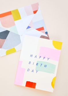 two greeting cards with the words happy birthday written on them and colored squares in different colors