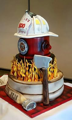 a fire hydrant cake with flames and a hat on top