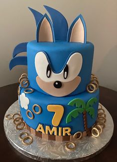 a birthday cake with a sonic the hedgehog theme on it's top tier