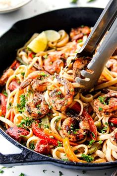 a skillet filled with pasta and shrimp