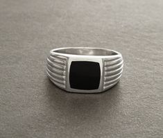 Fantastic Black Onyx Ring. The ring features an linear edged pattern around the square stone held in the centre, which is a Onyx Gemstone in a wonderful deep Shiny Black Color. The ring shank is edged to show detail and looks lovely with the darkness of the onyx. Bit of a modern look with a Art Deco spirit. A great Ring for guys! ► DIMENSIONS: * Onyx stone size: 1.0 cm x 1.0 cm * Average silver weight: 5.4 gr. ► PRODUCTION METHOD: 💓 Handmade with Love and Care - Because it's better that way 💓 Modern Black Ring With Rectangular Stone, Rings Ideas, Signet Ring Men, Men Bracelet, Ring Men, Jewelry Black, Black Onyx Ring, Ring Black, Onyx Ring